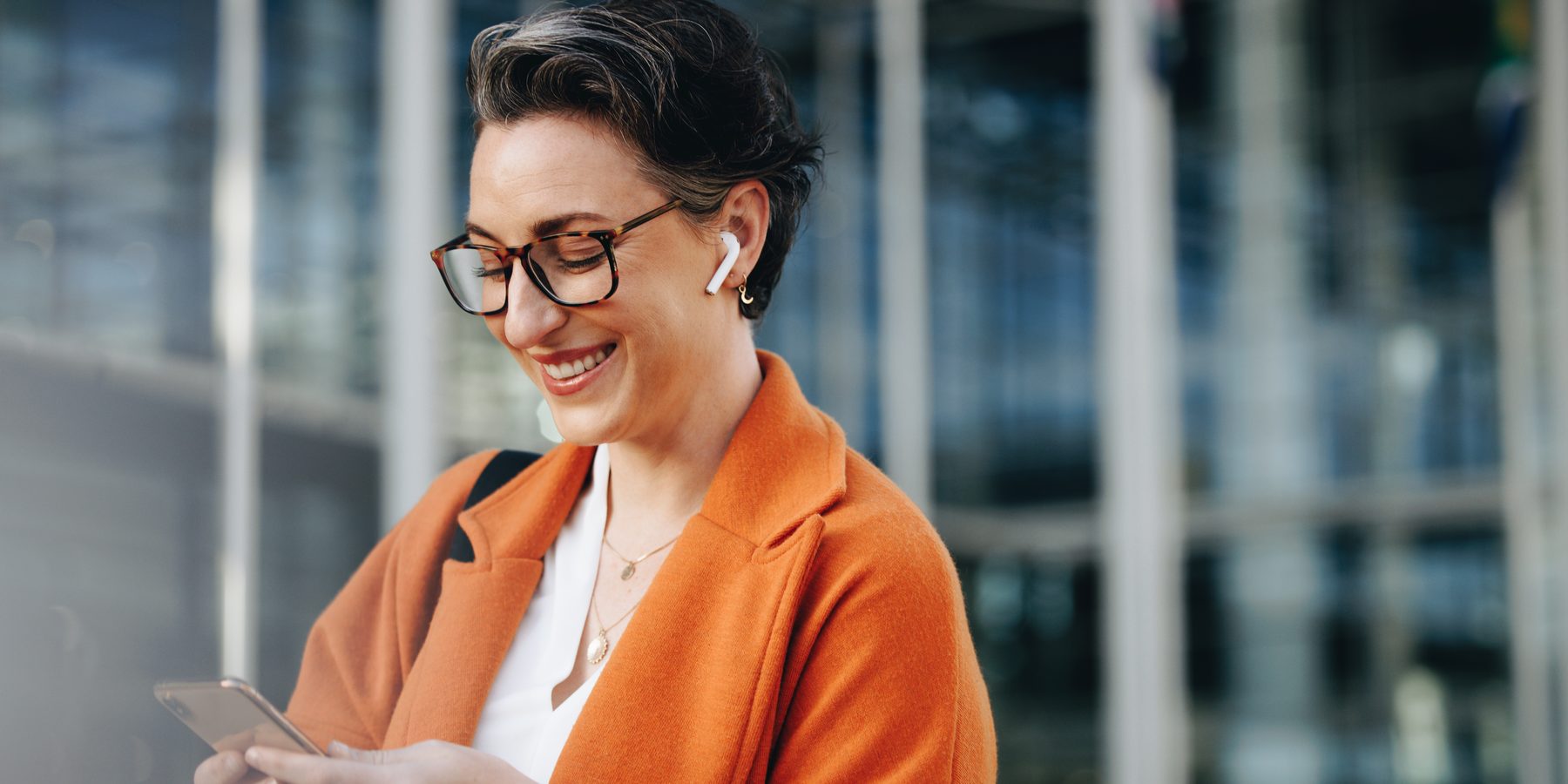 A woman checking her phone on her way to work