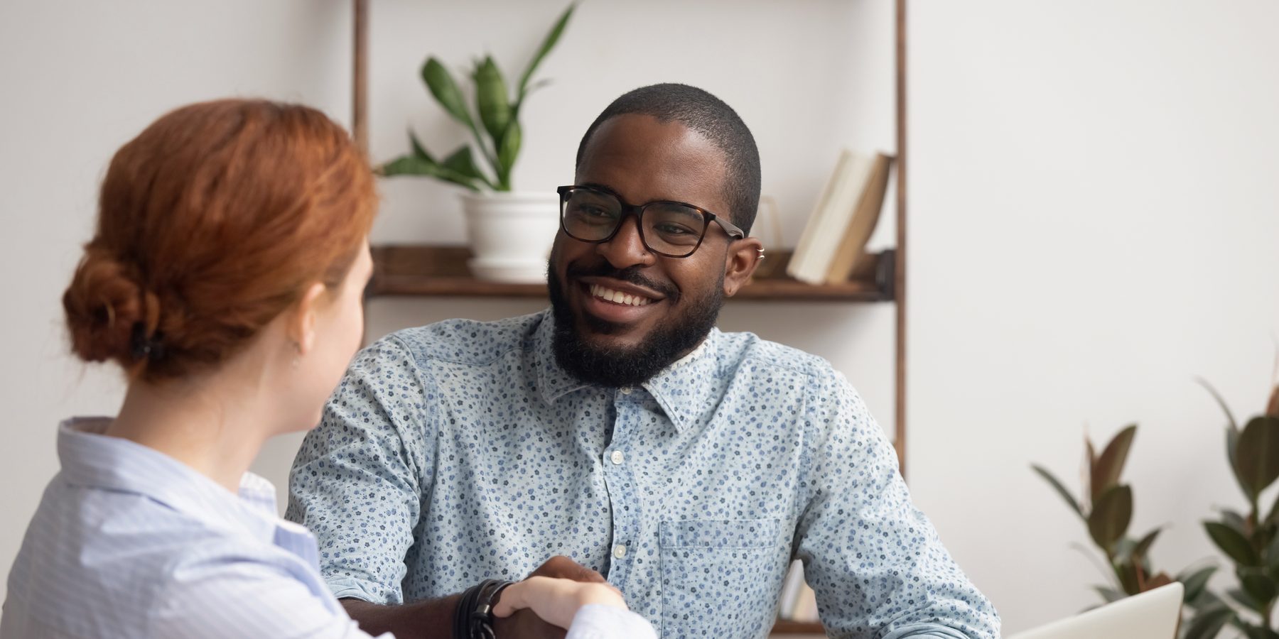 A hiring manager and a candidate talking across a desk