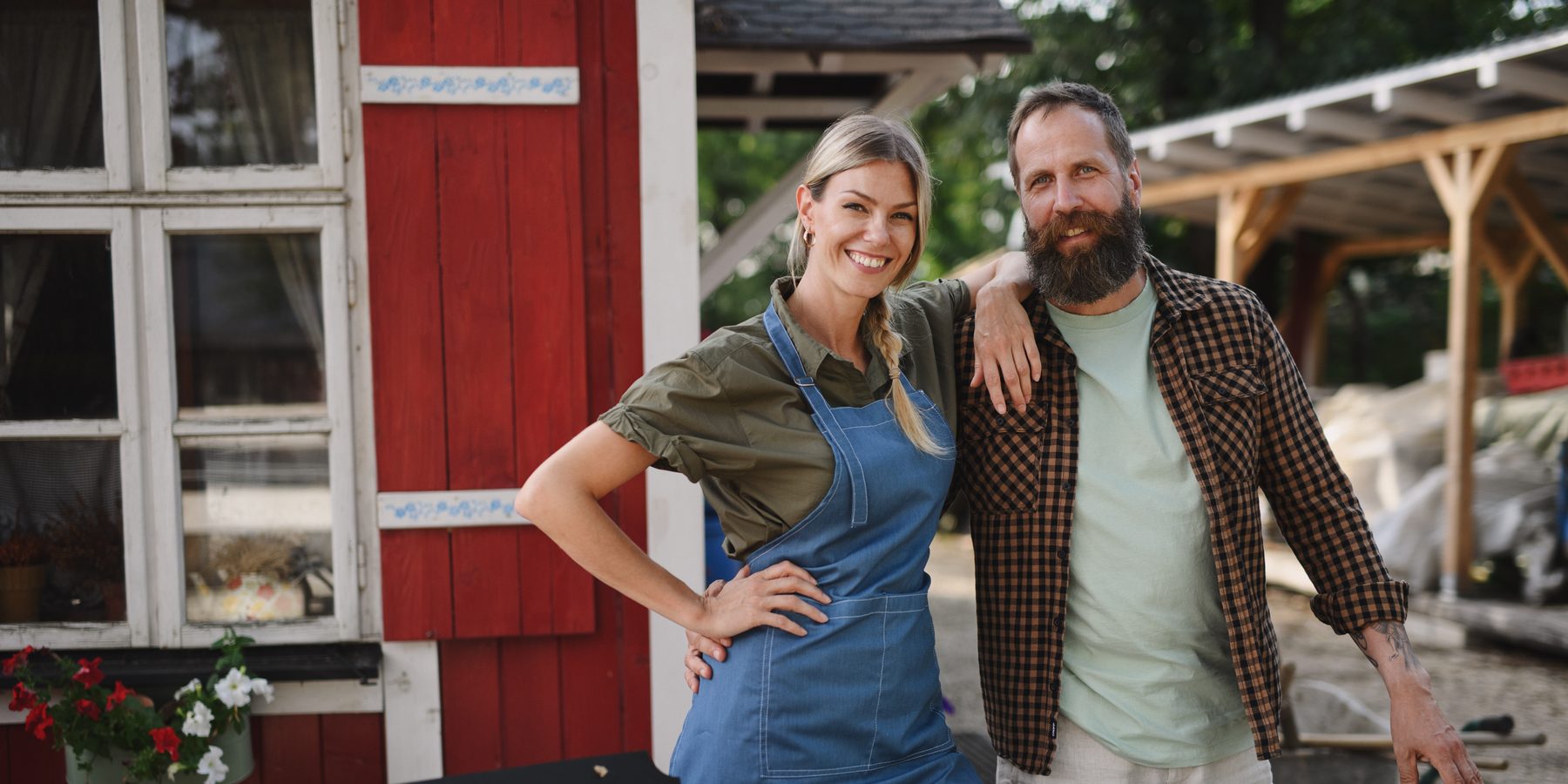Two owners outside their small farm business