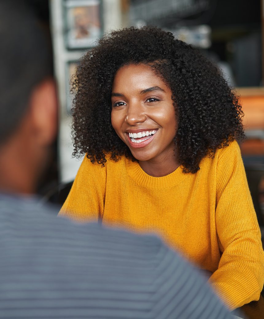 A jobseeker in conversation across a table, smiling
