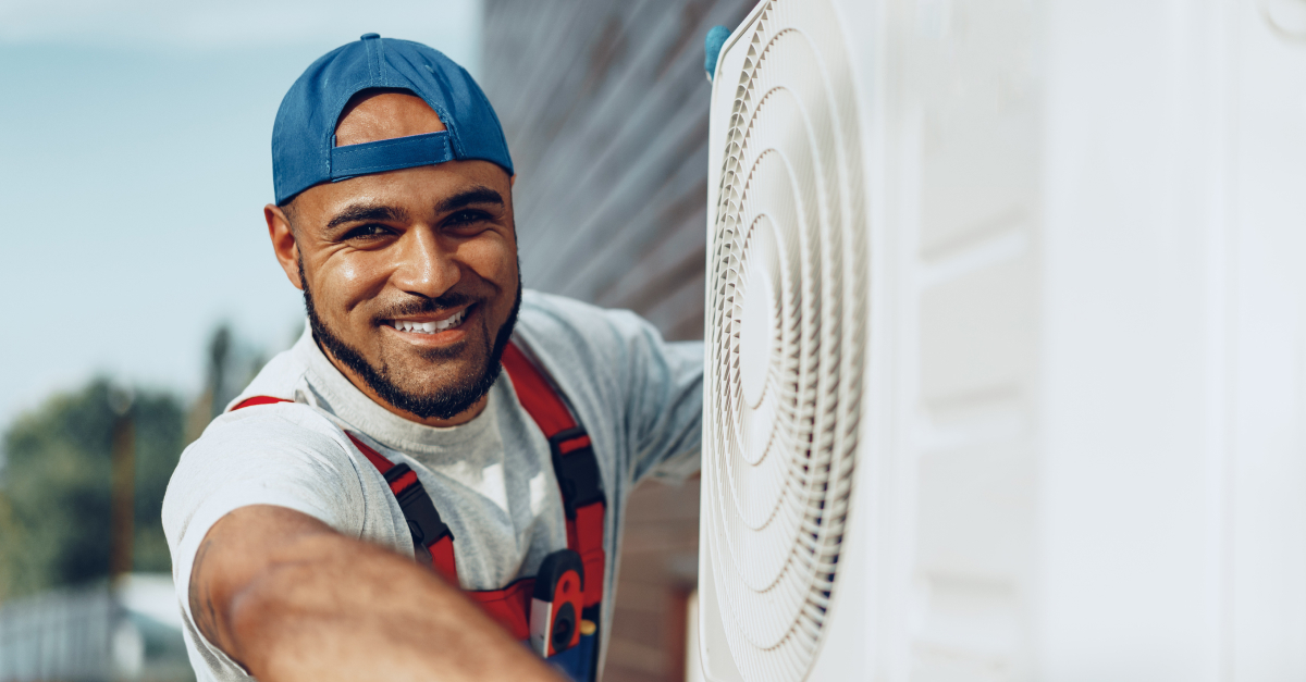 man working on an outdoor air conditioning unit